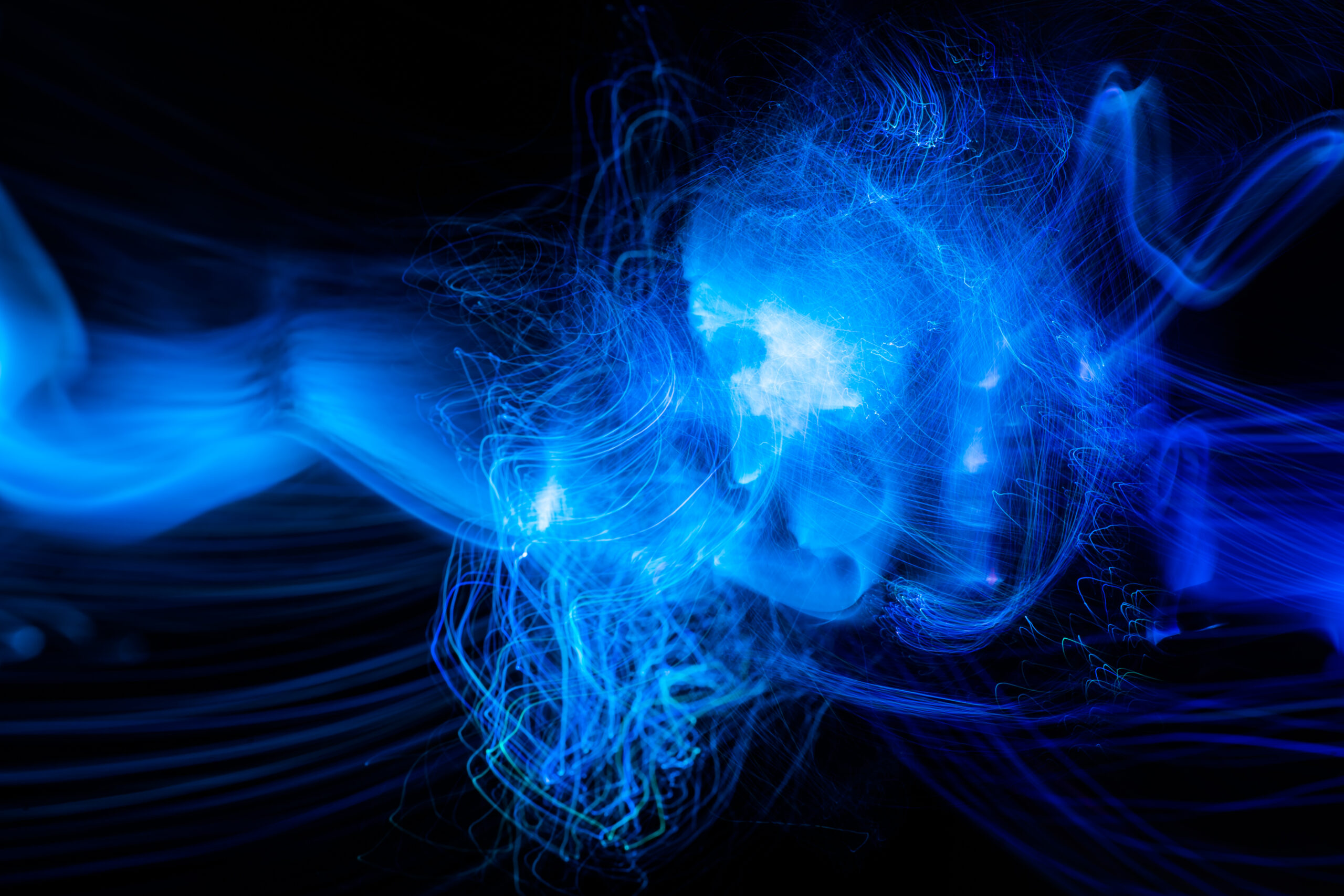 Blue light wave of energy explosion with blue glow.