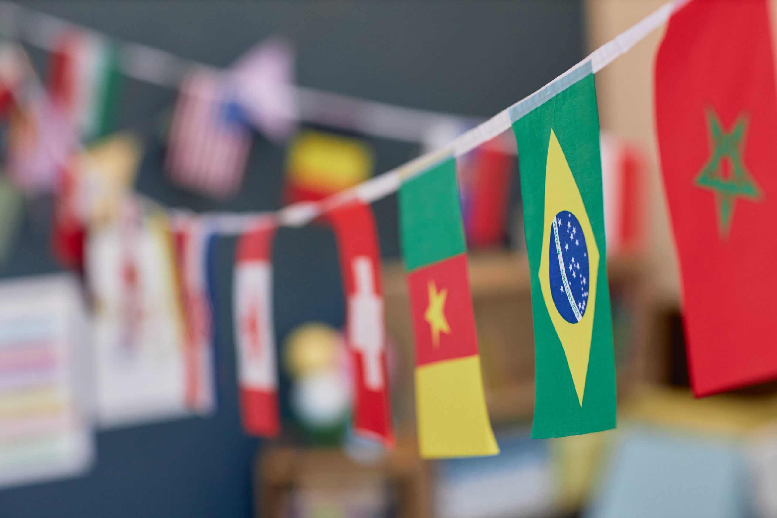 Close-up of various country flags decorating a classroom.