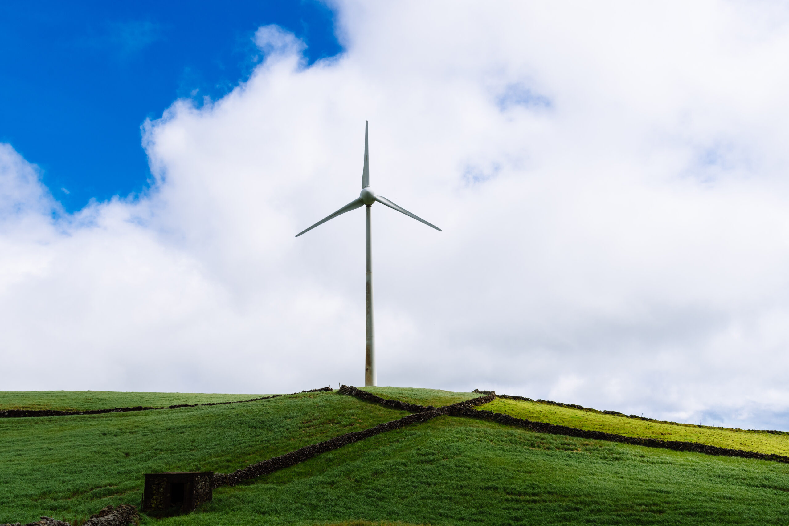 Panoramic view of wind farm or wind park, with high wind turbines for generation electricity with copy space. Green energy concept. Terceira Island, Azores, Portugal