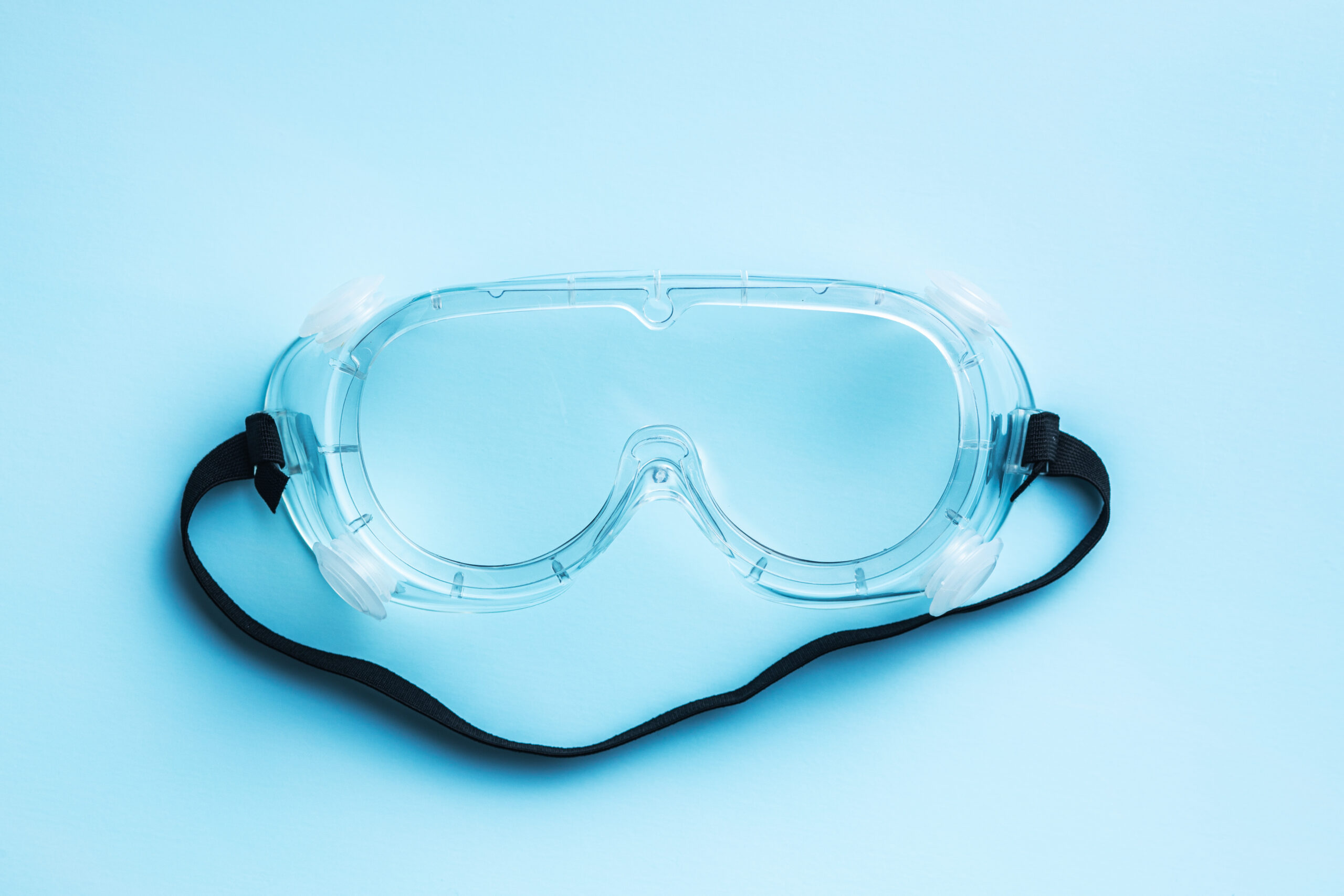 Protective goggles with a blue background.