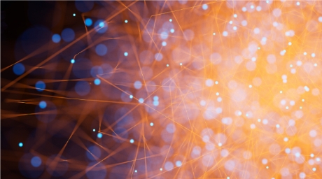 Abstract network of blue and orange dots and lines transitioning into a glowing orange area.