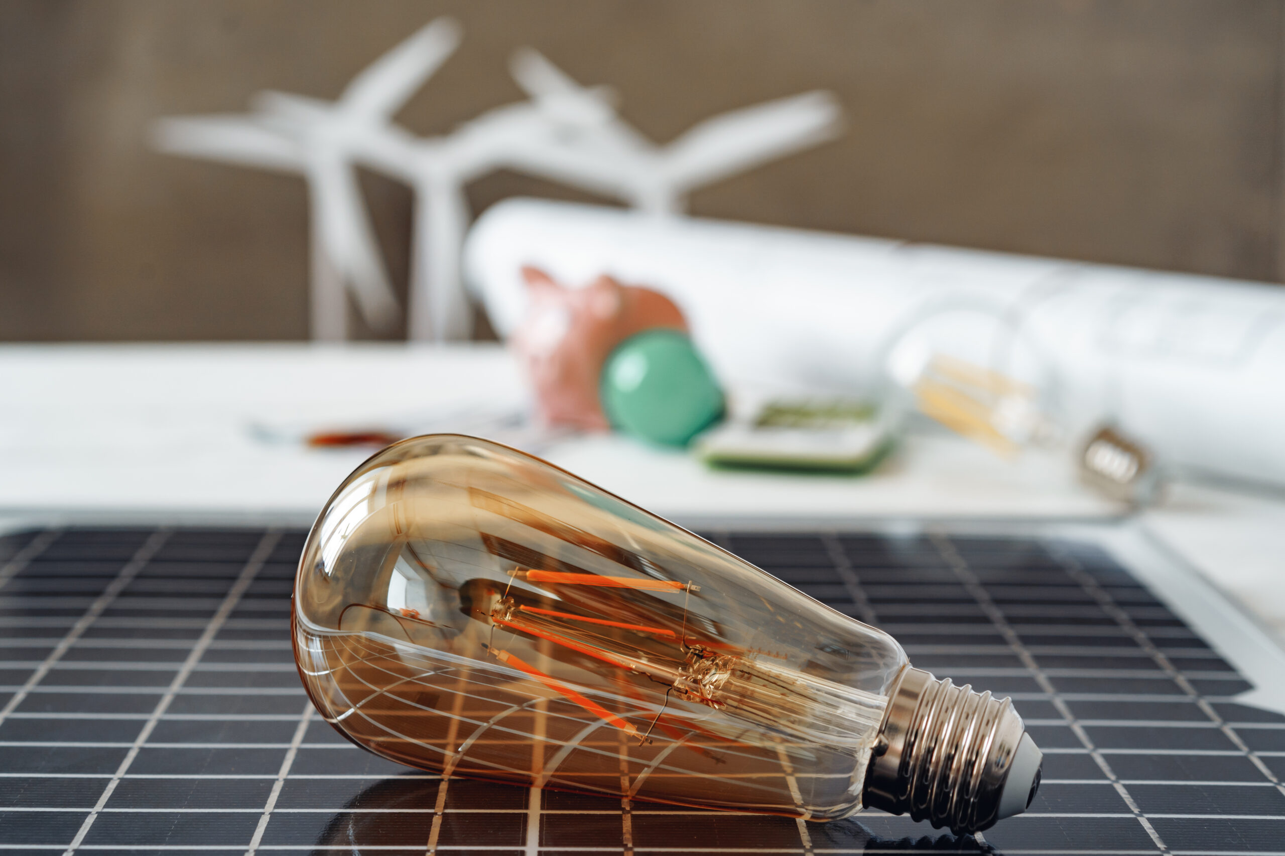 Light bulb resting on top of a solar panel.