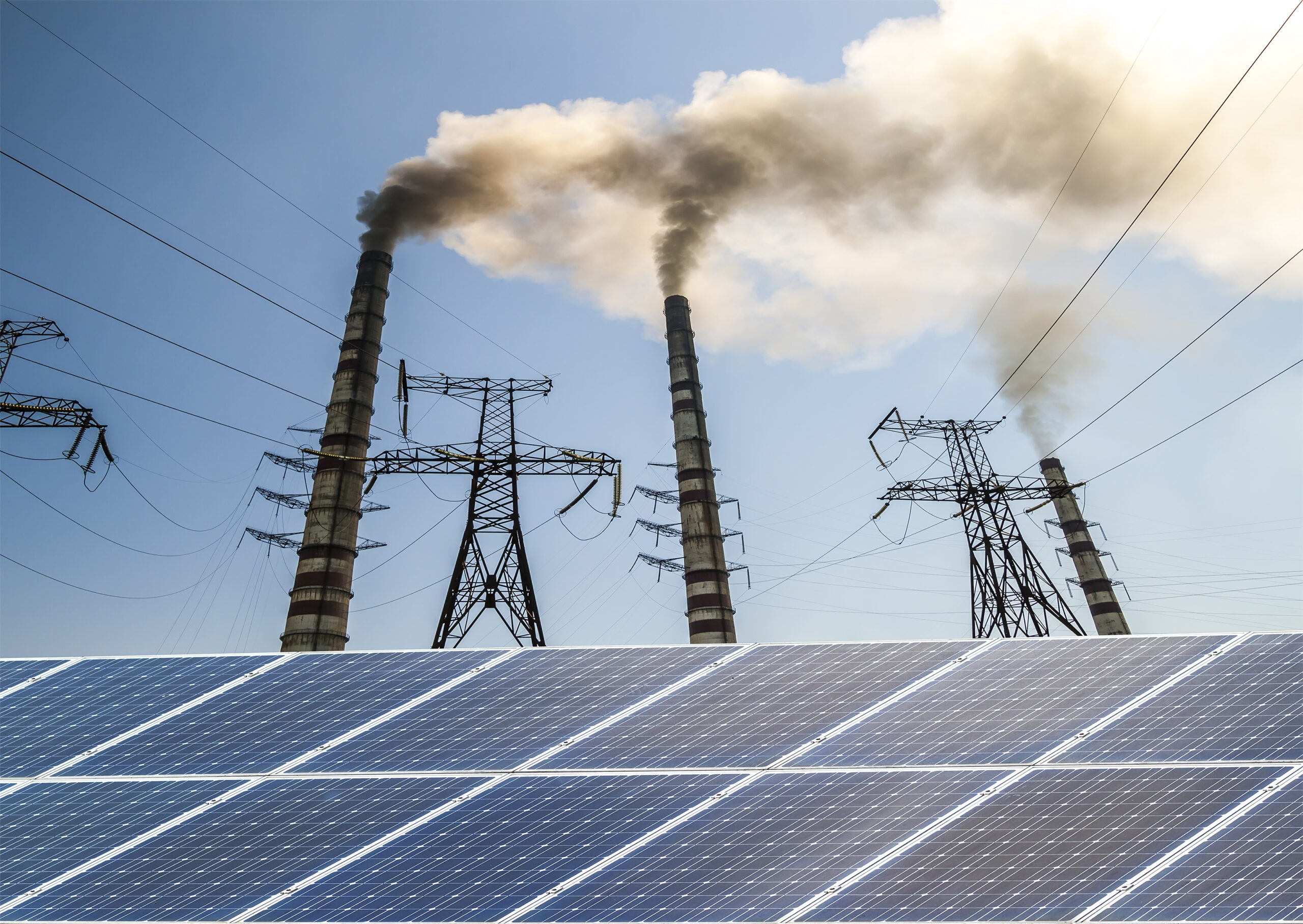 Solar panels against fuel coal power plant. Sustainable development and renewable resources concept.