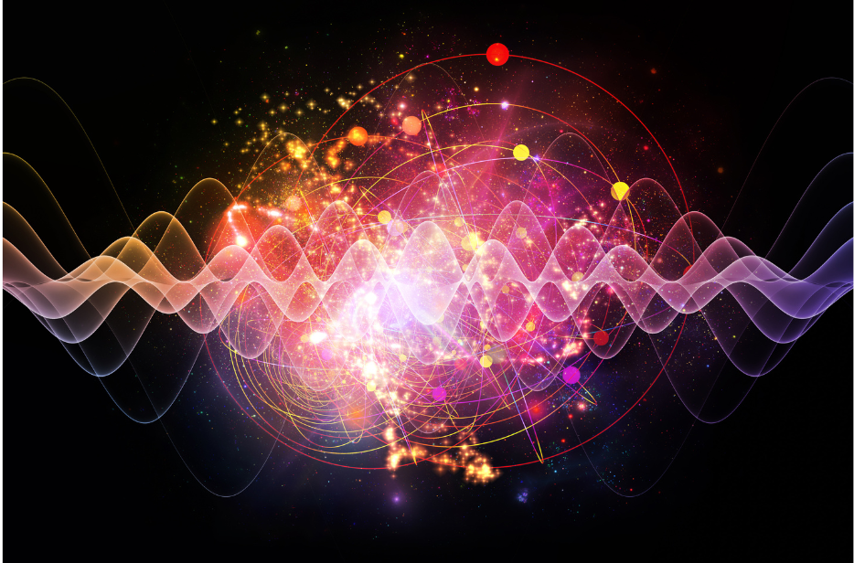 Abstract visualization of quantum waves and particles — colorful light patterns, energy waves, and particle orbits on a dark background.