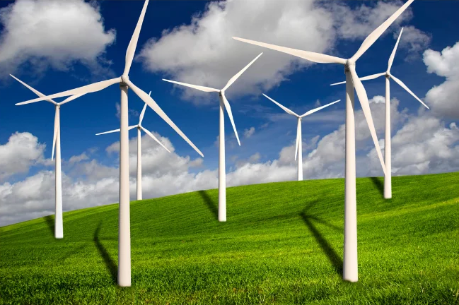 Wind turbines on a green grass field.